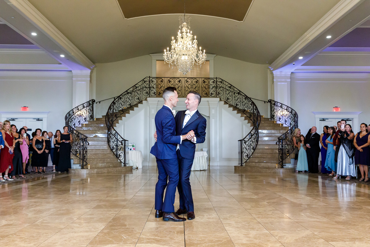 two grooms sharing their first dance in the aria ballroom