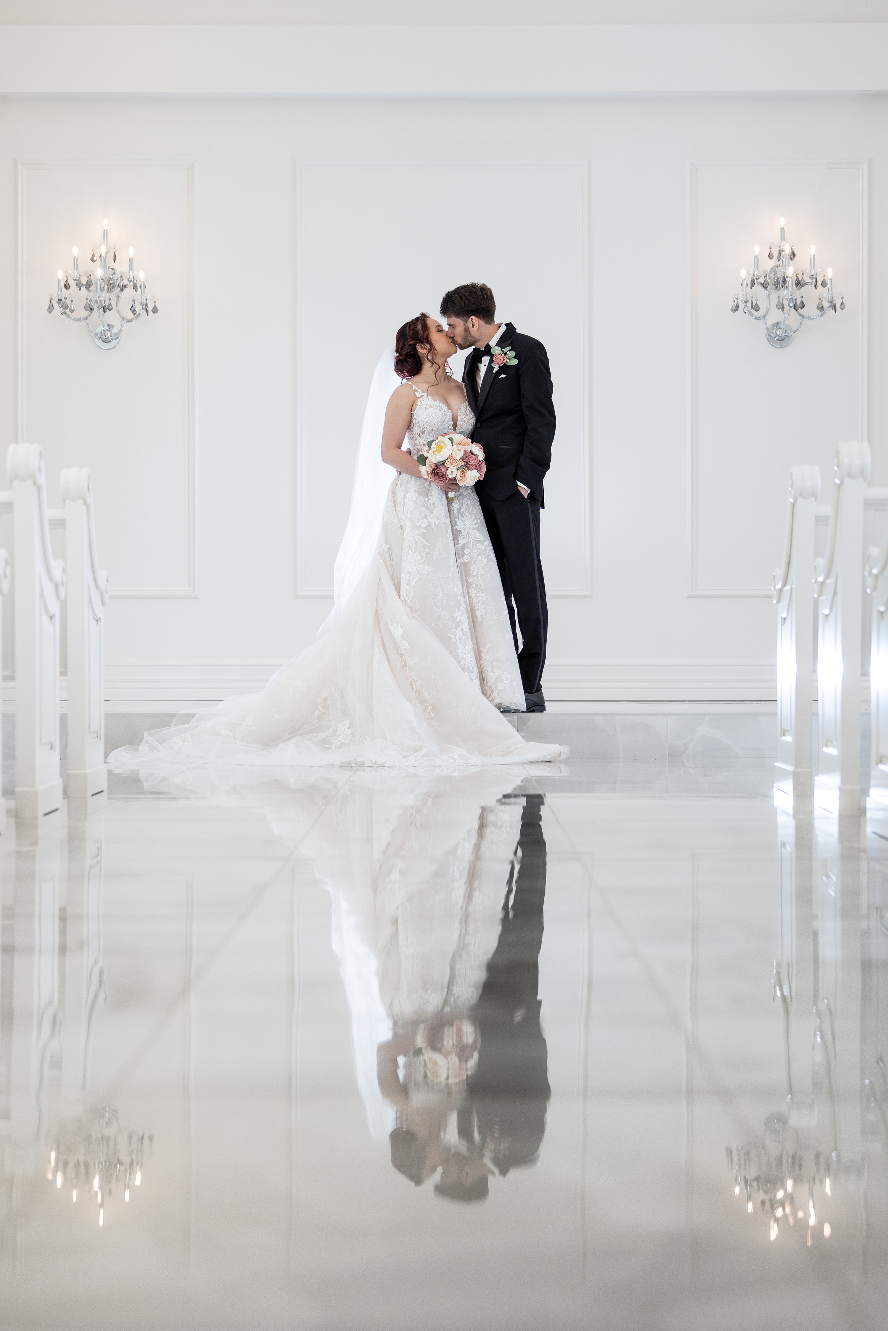 a bride and groom kissing in the aria chapel
