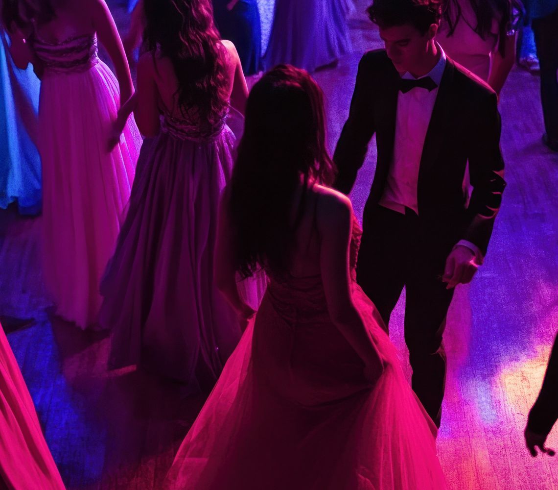 students at prom dancing in the aria ballroom with blue and pink lights