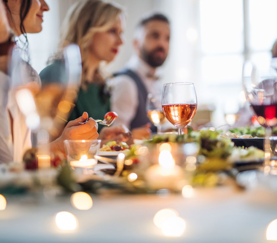 2 woman and a man sitting at a table enjoying dinner
