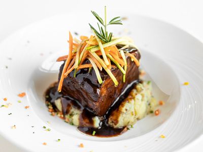 Elegantly plated entree on a white plate.