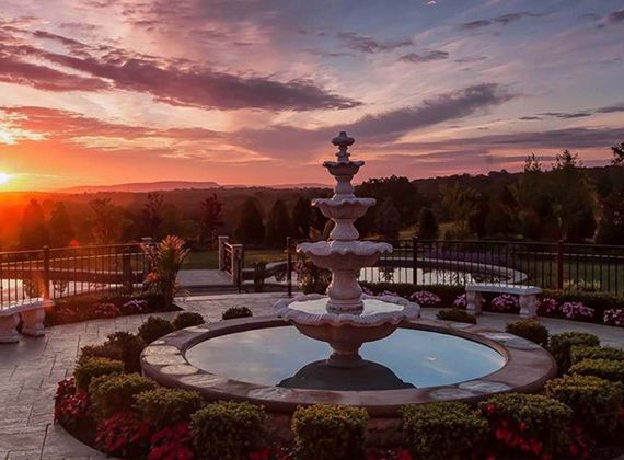 aria's yard showcasing a fountain and a beautiful sunset